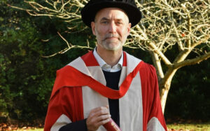 Tom Clarke in cap and gown on his Graduation Day