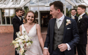 James & Ali at their wedding, holding hands