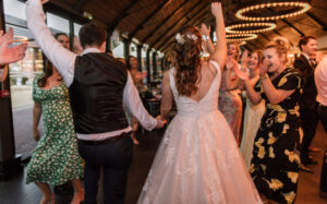 James & Ali McLennan-Jones holding hands and dancing at their wedding