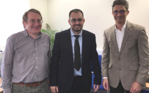 Imran standing between two professors from the University of Reading