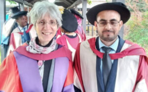 Imran graduating from the University of Reading, standing next to one of his professors.