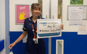 Amy in her midwifery uniform standing in the hospital