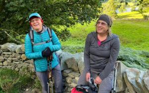 Celia and her wife Sue laughing at the camera while on a walk