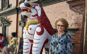 Hilary standing next to a statue in Nepal
