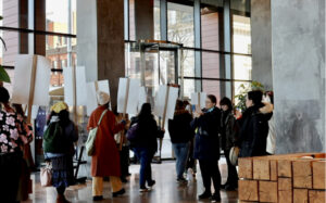 Students with posters marching into Thames Tower