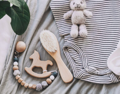 An array of baby equipment laid out on top of a moses basket.