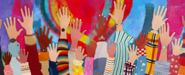 Group of diverse people with arms and hands raised towards a hand painted heart.