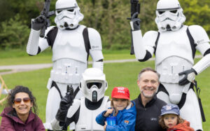 A family posing with stormtroopers
