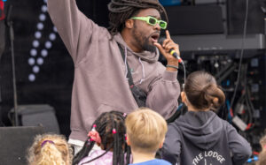 A man singing in front of some children