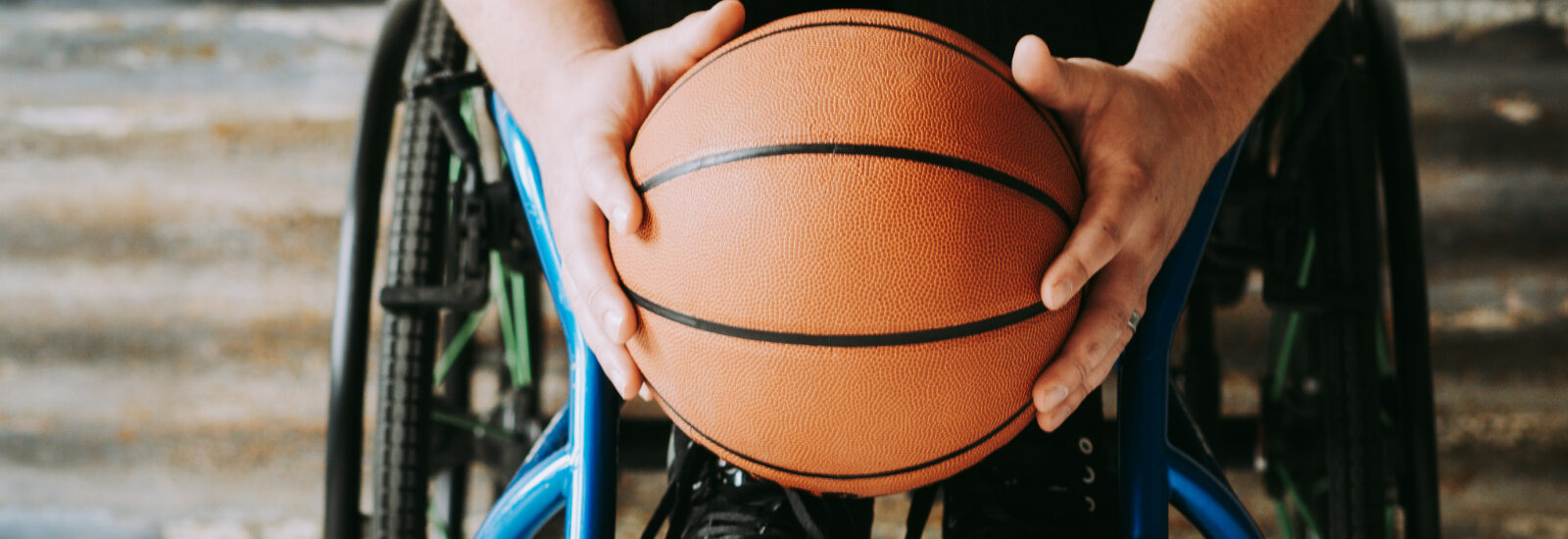 A person in a wheelchair holding a basketball