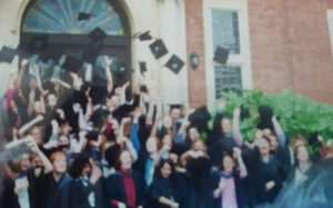 Sarah and friends tossing their caps in the air at graduation