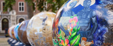 A trail of globes with artwork on