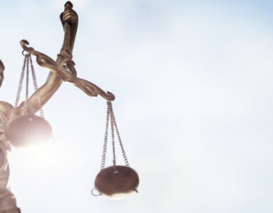 Legal law concept statue of Lady Justice with scales of justice sky background