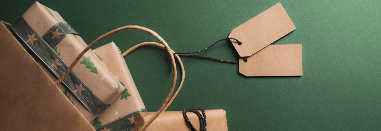 Presents wrapped in brown paper against a green background