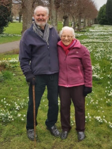 Bruce and Jean standing together on a stretch of grass in 2023