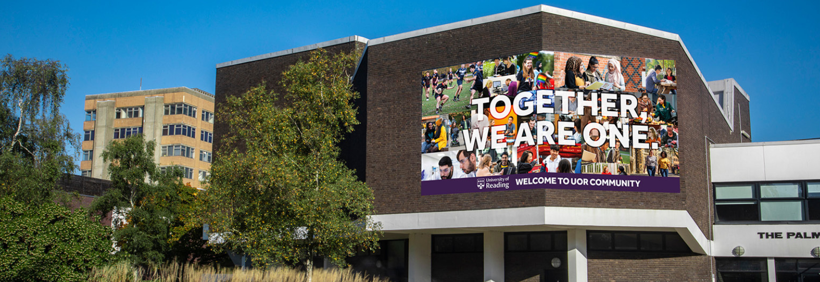 Photo of a banner on the Palmer Building, reading Together We Are One