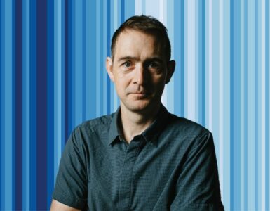 Ed Hawkins in front of the climate stripes