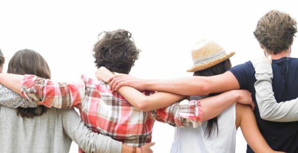 A group of people with their arms around each other's shoulders