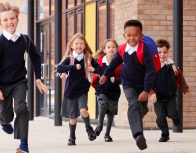 Schoolchildren running along a path