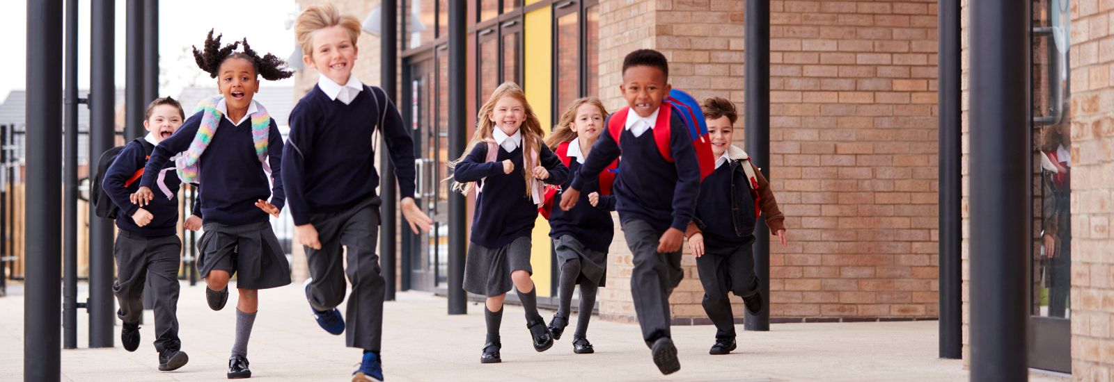 Schoolchildren running along a path