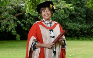 Ginny holding her honorary degree certificate