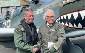 Alan shaking hands with pilot in front of a Spitfire 