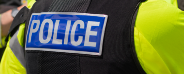 Police badge on the back of a police uniform