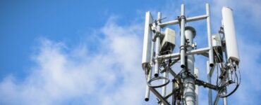 Telecommunications Tower with antennas on blue sky with cloud