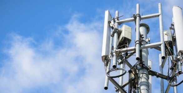 Telecommunications Tower with antennas on blue sky with cloud