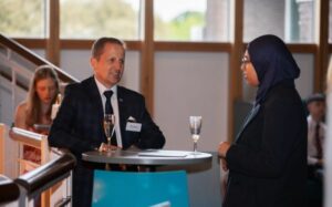A mentor and mentee chatting at celebratory event