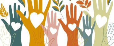 Hands raised in the air with hearts drawn on them