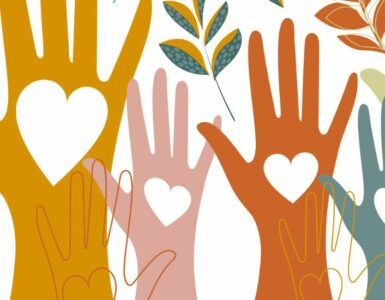 Hands raised in the air with hearts drawn on them