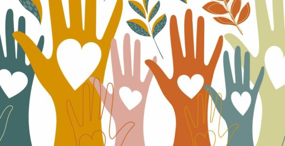 Hands raised in the air with hearts drawn on them