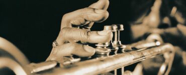 Close-up image of a man playing the trumpet