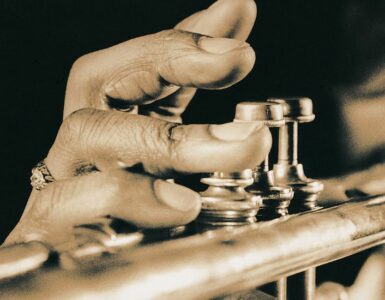 Close-up image of a man playing the trumpet