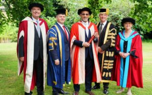 Image of Dr Nicholas Bannan, UoR Vice-Chancellor, Dr Wes, UoR Chancellor and Dr Rebecca Berkley at Dr Wes' honorary graduation ceremony
