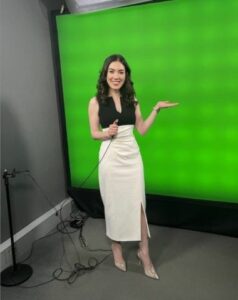 Sabrina standing in front of a green screen