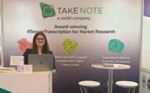 Emma standing behind her company's stand at a fair
