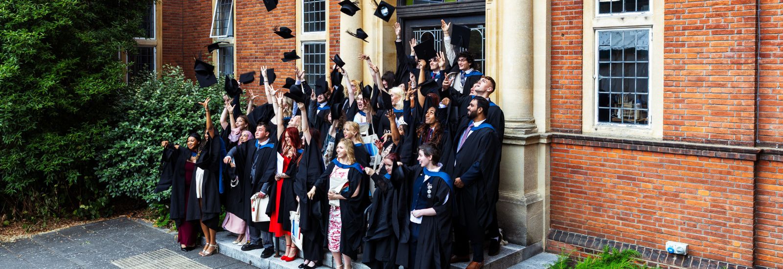 Graduates throwing caps in air