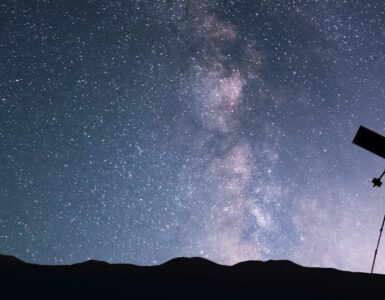 Image of a telescope silhouette on the background of the milky way galaxy.
