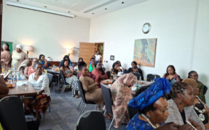 Group of women sat round tables looking to the front