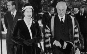 Photograph of HRH Queen Elizabeth II and the Chancellor, Lord Templewood, arriving at the opening of the Faculty of Letters Building, with HRH Prince Philip in the background. (22 March 1957)