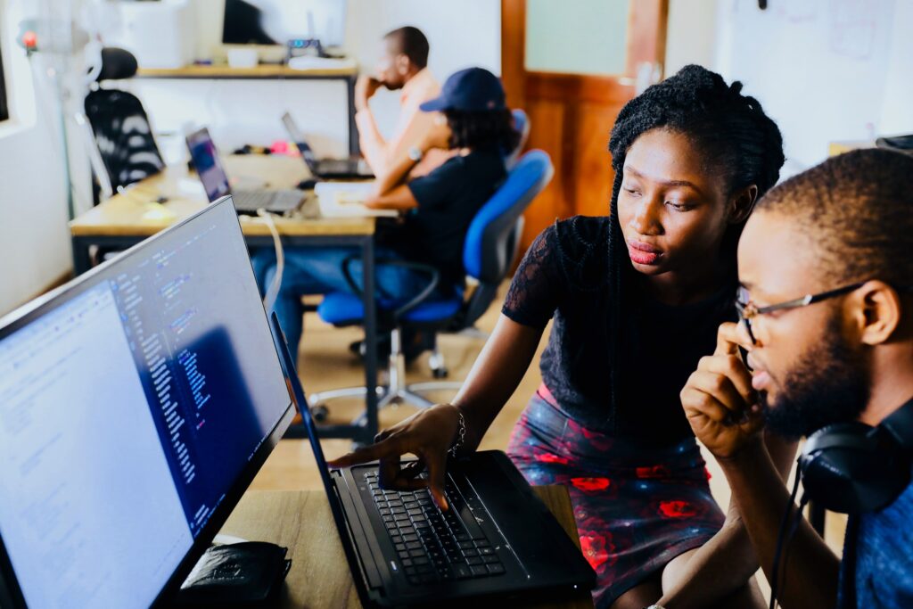 woman and man sitting in front of a computer