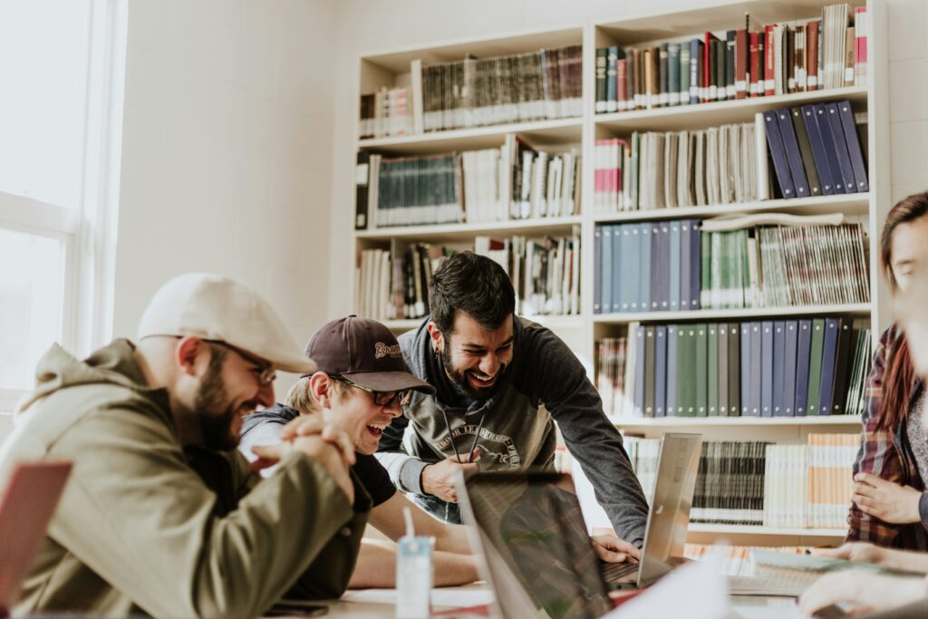 A group of students working at one laptop