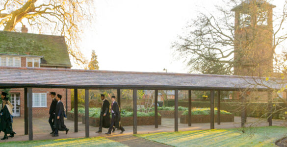 Graduates walk across London Road campus