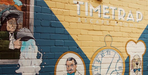 A brick wall advertising Time Trap escape rooms