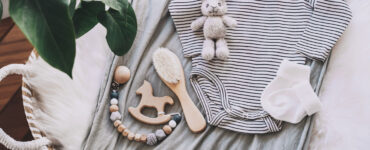 An array of baby equipment laid out on top of a moses basket.