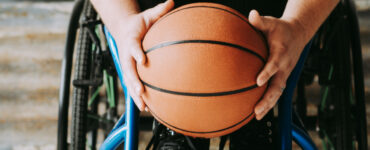 A person in a wheelchair holding a basketball