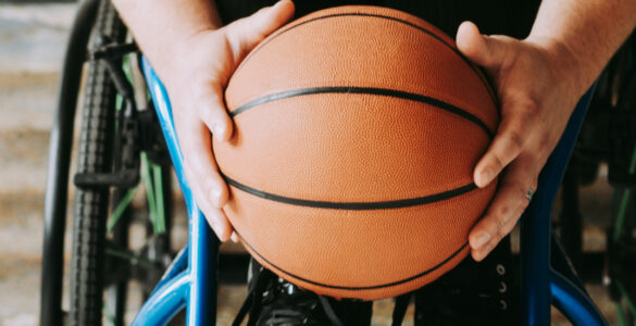 A person in a wheelchair holding a basketball