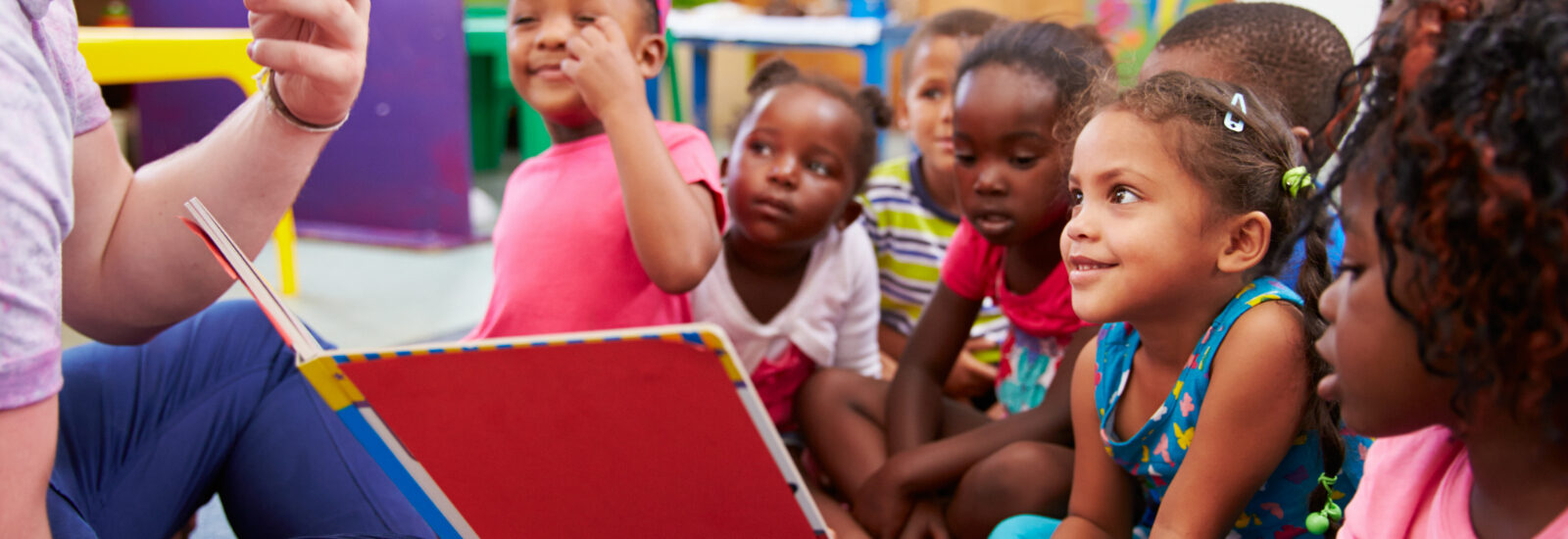 Group of primary aged schoolchildren listening to a story
